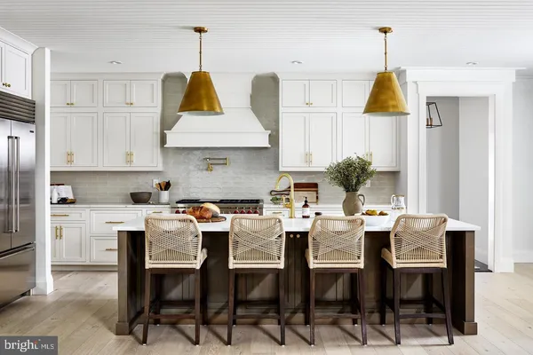a view of kitchen with dining table chairs and wooden floor