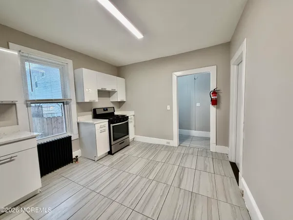 a kitchen with granite countertop a refrigerator and a stove