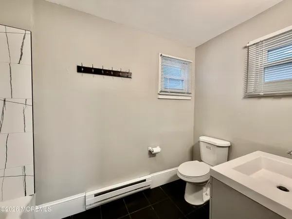 a white toilet sitting next to a bathroom sink