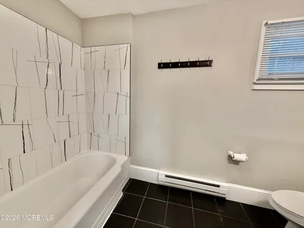 a bathroom with a bathtub and shower