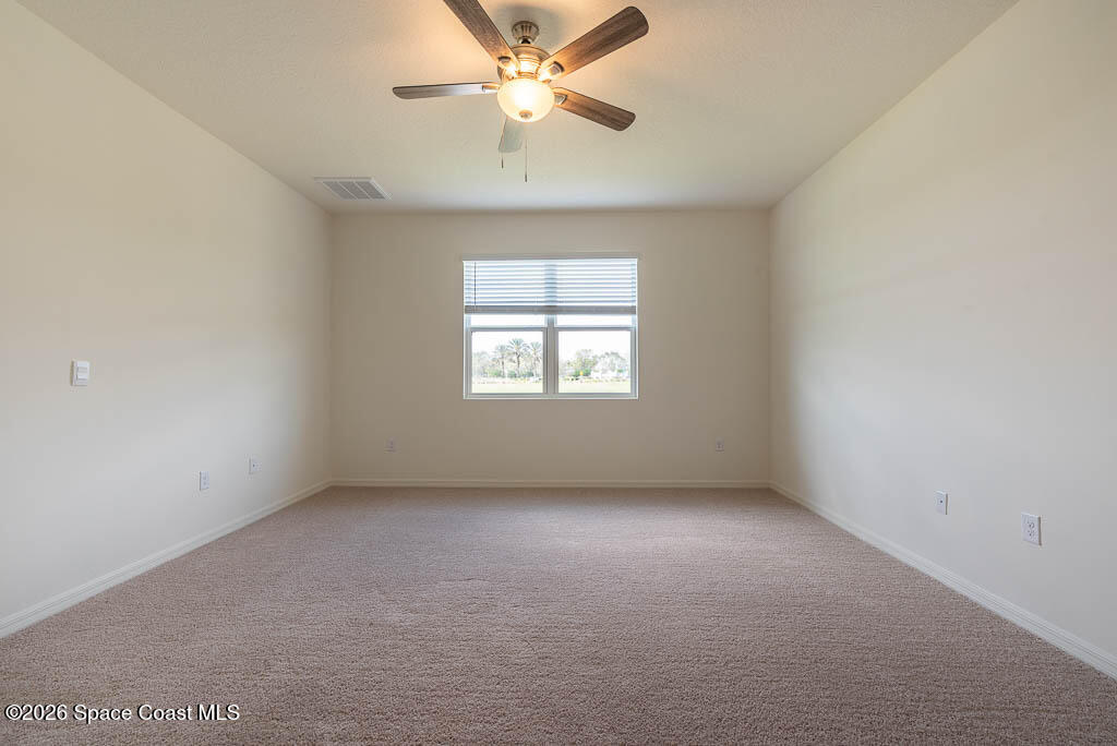 1863 Farmhouse Road Southeast Palm Bay, FL 32909 - Photo 13 of 44 an empty room with a window and a fan
