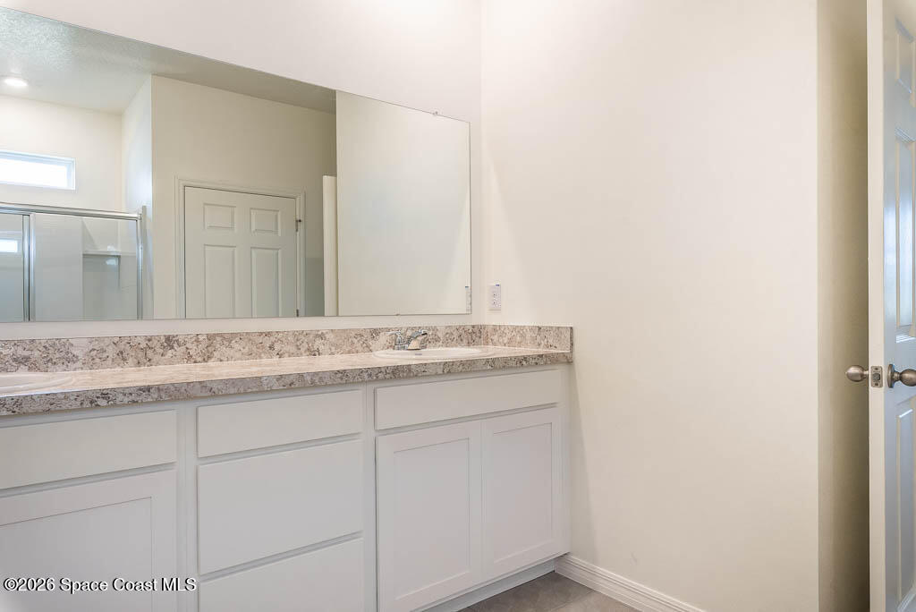 1863 Farmhouse Road Southeast Palm Bay, FL 32909 - Photo 14 of 44 a bathroom with a granite countertop sink and a mirror