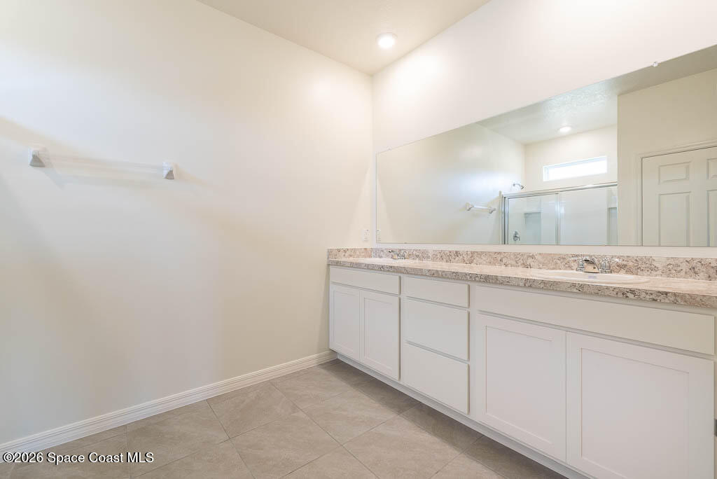 1863 Farmhouse Road Southeast Palm Bay, FL 32909 - Photo 15 of 44 a bathroom with a granite countertop sink and a mirror