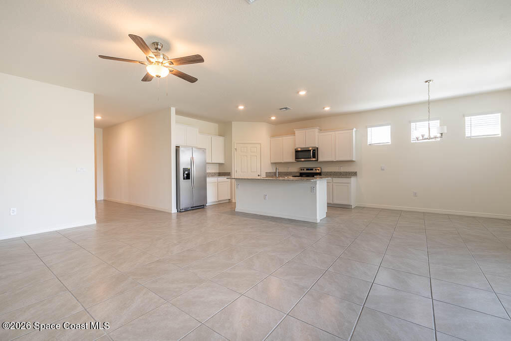 1863 Farmhouse Road Southeast Palm Bay, FL 32909 - Photo 17 of 44 a view of a kitchen with a sink and stainless steel appliances
