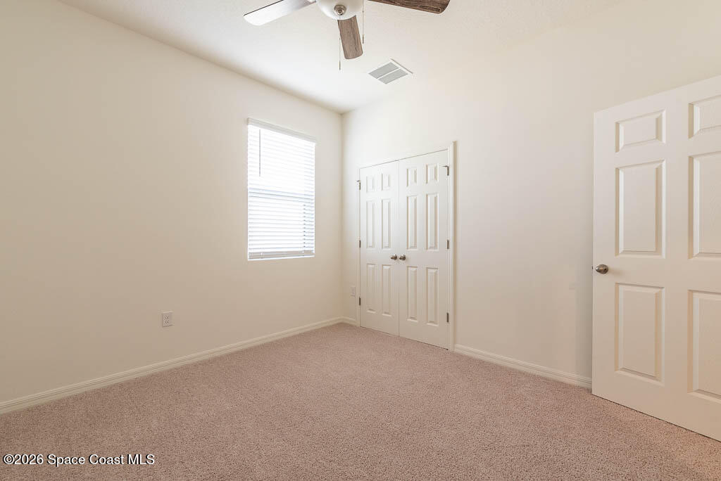 1863 Farmhouse Road Southeast Palm Bay, FL 32909 - Photo 23 of 44 an empty room with windows and fan