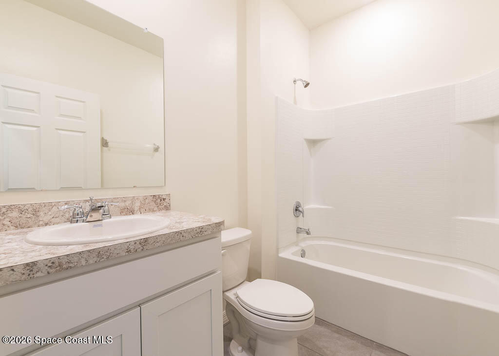 1863 Farmhouse Road Southeast Palm Bay, FL 32909 - Photo 28 of 44 a bathroom with a granite countertop sink a toilet and a bathtub