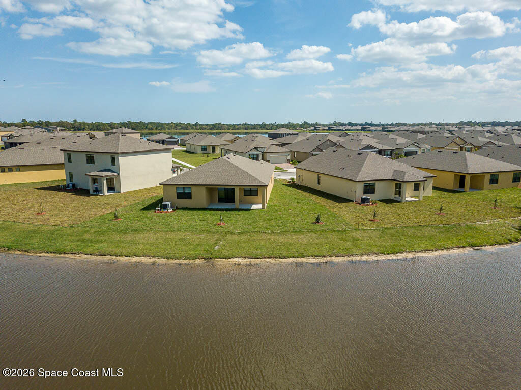 1863 Farmhouse Road Southeast Palm Bay, FL 32909 - Photo 33 of 44 an aerial view of residential houses with outdoor space