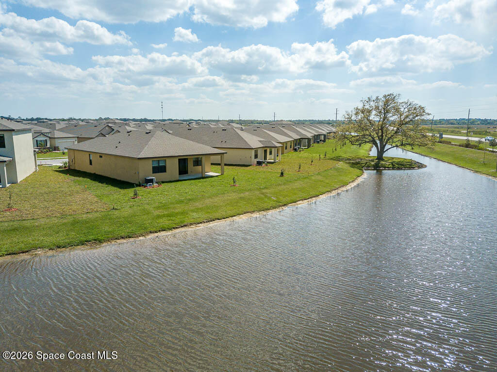 1863 Farmhouse Road Southeast Palm Bay, FL 32909 - Photo 34 of 44 a view of a lake with houses in the back