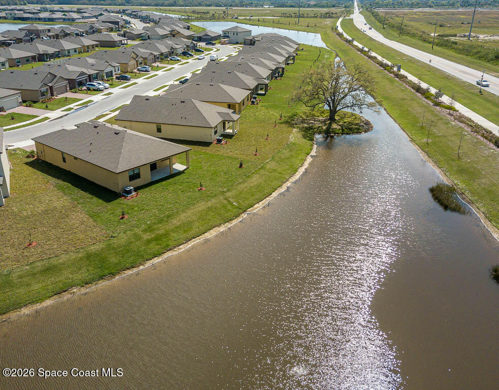 1863 Farmhouse Road Southeast Palm Bay, FL 32909 - Photo 36 of 44 a view of a lake with a yard