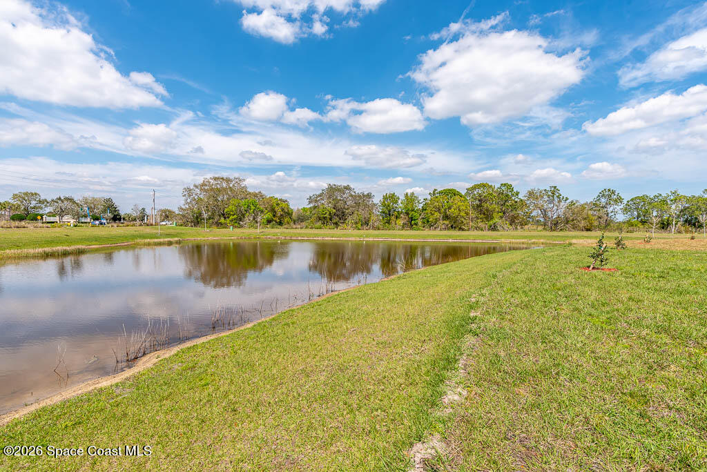 1863 Farmhouse Road Southeast Palm Bay, FL 32909 - Photo 4 of 44 a view of a lake with houses in the back