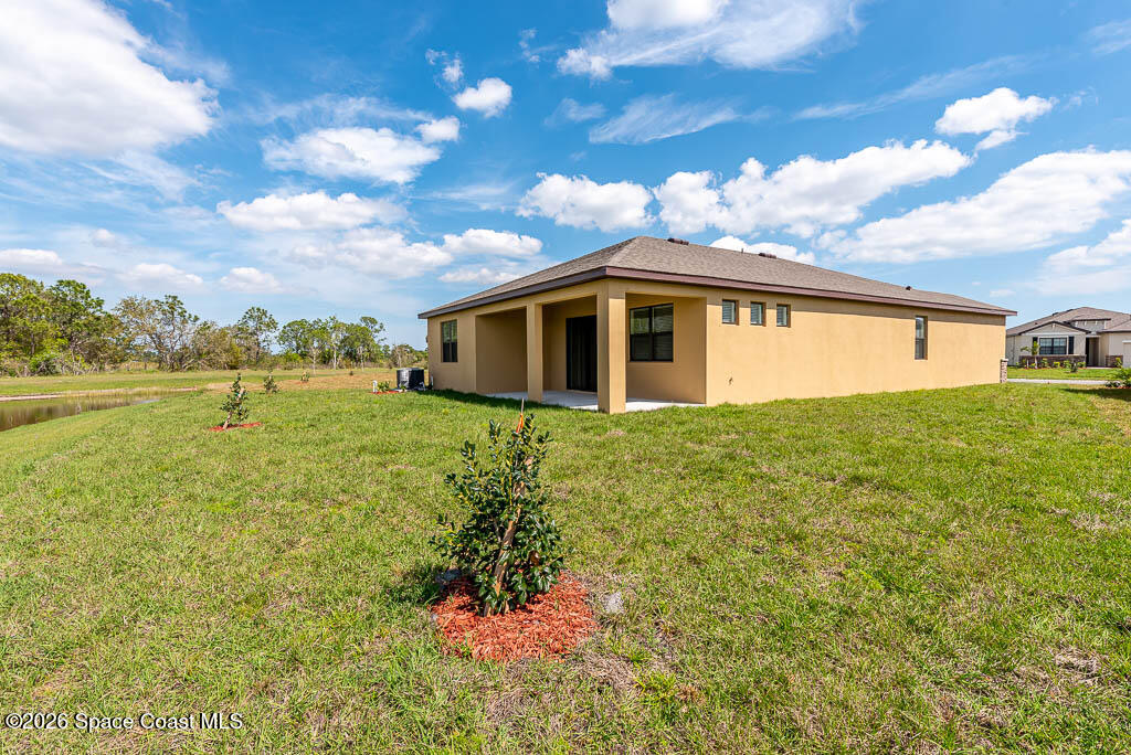 1863 Farmhouse Road Southeast Palm Bay, FL 32909 - Photo 6 of 44 a view of a house with a yard