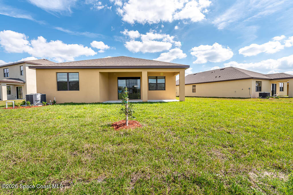 1863 Farmhouse Road Southeast Palm Bay, FL 32909 - Photo 7 of 44 a front view of house with yard and porch