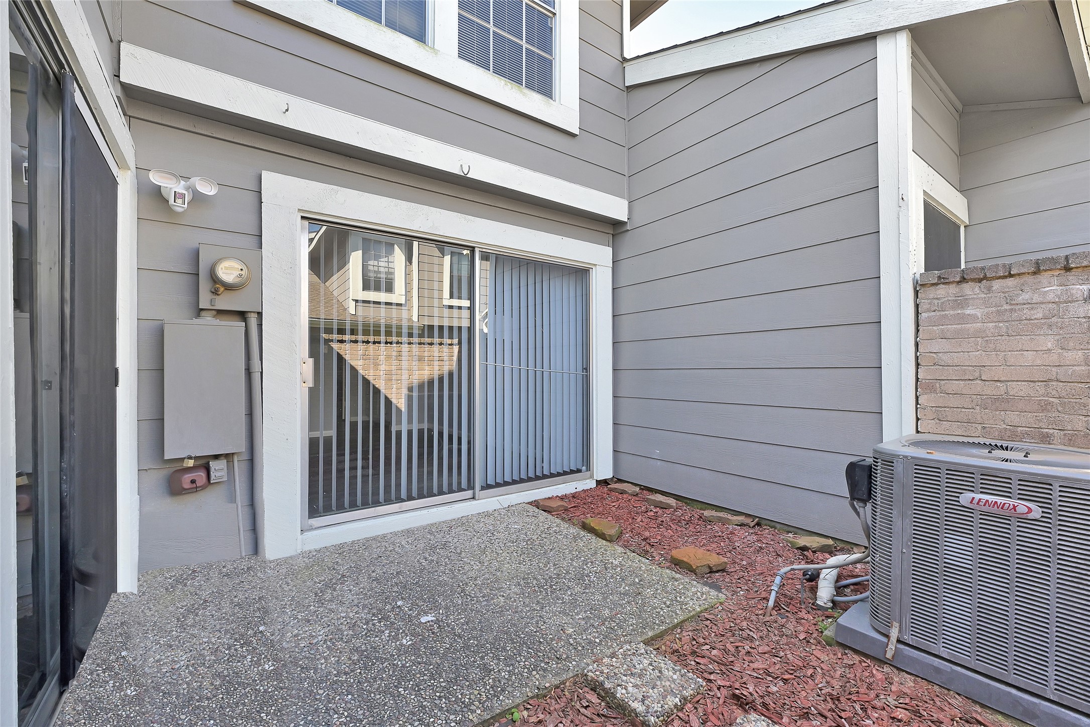 12111 Lemon Ridge Lane, Unit 121 Houston, TX 77035 - Photo 5 of 25 a view of a porch with wooden floor and a yard