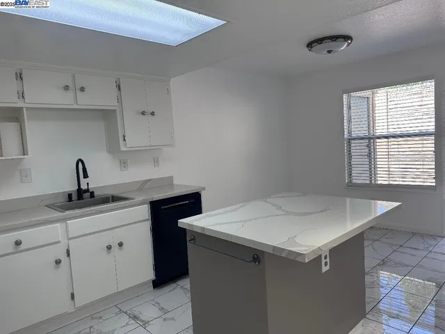 a kitchen with a sink cabinets and utility