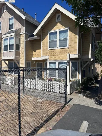 a front view of a house with wooden fence