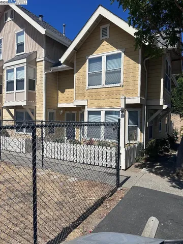 a front view of a house with wooden fence