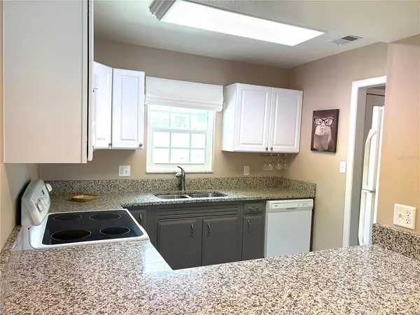 a kitchen with a sink stove and cabinets