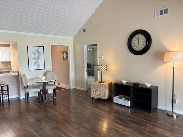 a view of a workspace with furniture and wooden floor