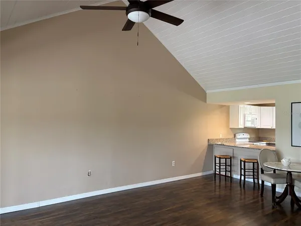 a view of a workspace with furniture and wooden floor