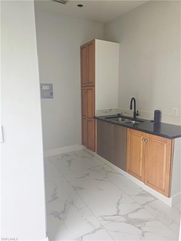 5321 Warren Street Naples, FL 34113 - Photo 16 of 21 a kitchen with a sink and cabinets