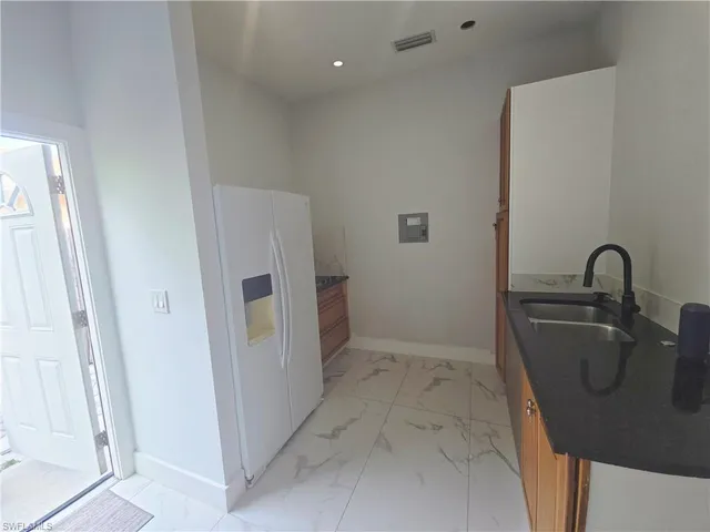 a bathroom with a granite countertop sink a toilet and shower