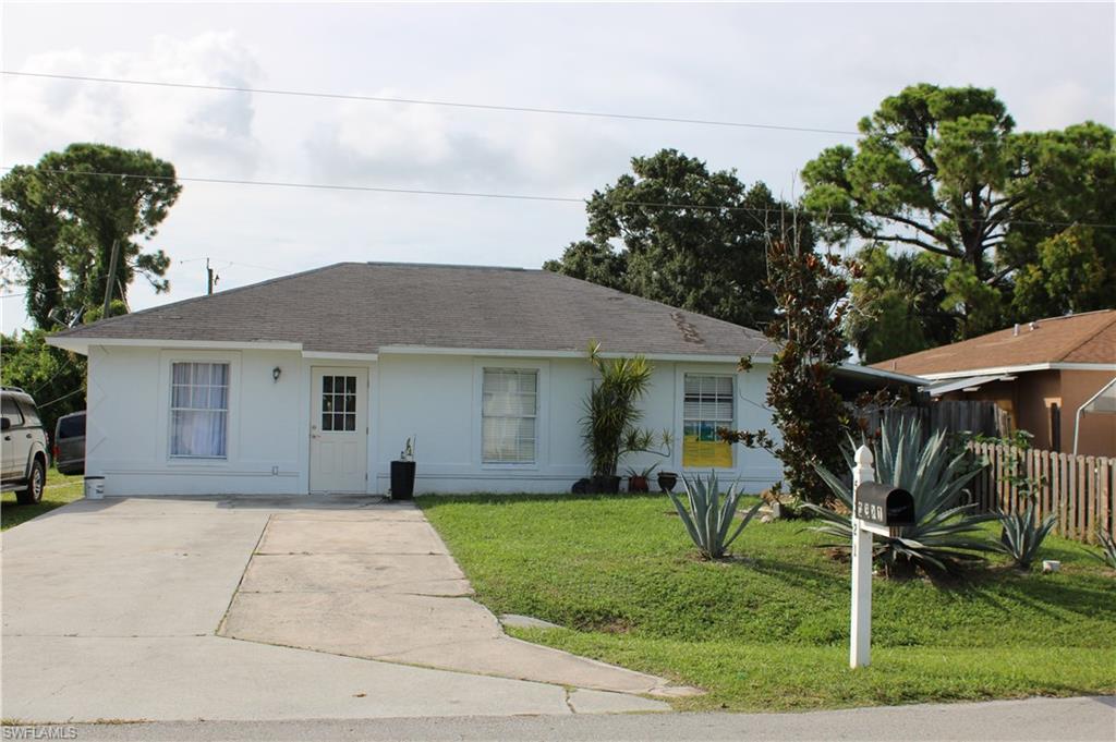 5321 Warren Street Naples, FL 34113 - Photo 2 of 21 a front view of house with yard and trees around