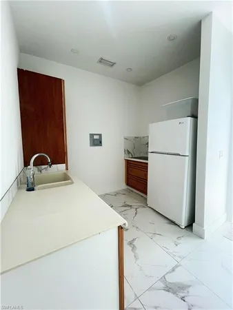 a view of a storage & utility room with sink