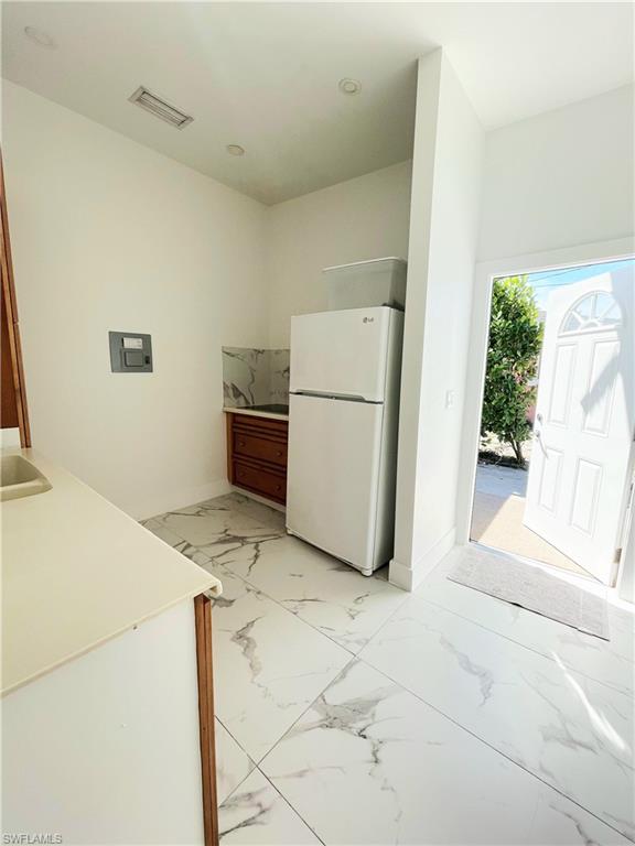 5321 Warren Street Naples, FL 34113 - Photo 22 of 26 a view of kitchen and utility room