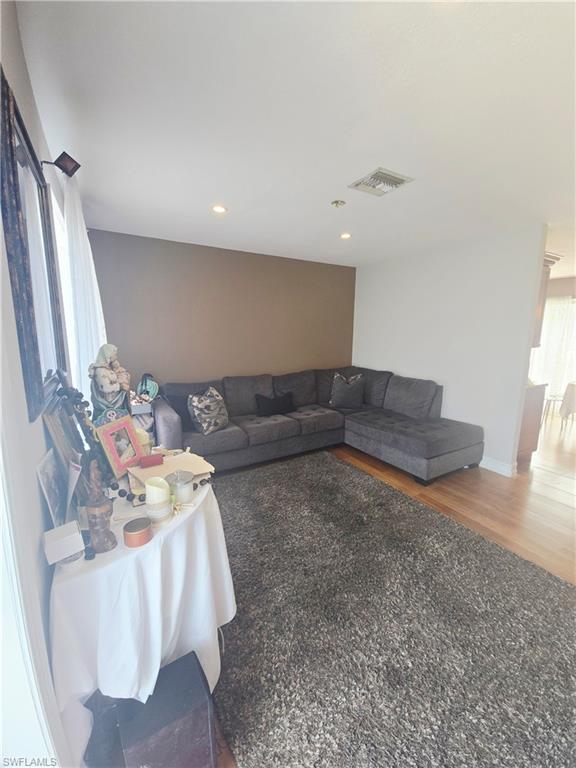 5321 Warren Street Naples, FL 34113 - Photo 3 of 21 a living room with furniture and a fireplace