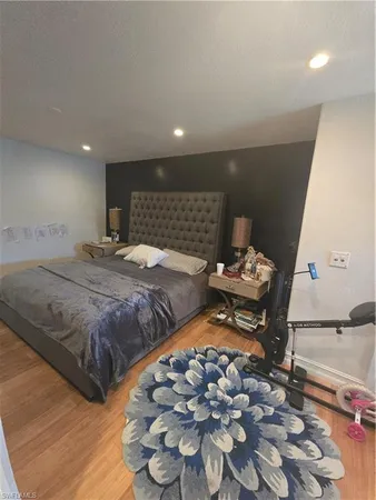 a bed room with a bed and a television