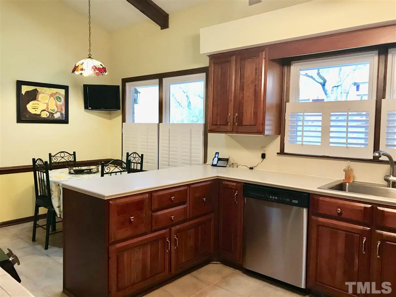 1115 Hunting Ridge Road Raleigh, NC 27615 - Photo 4 of 25 a kitchen with a sink and a stove