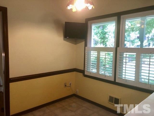 1115 Hunting Ridge Road Raleigh, NC 27615 - Photo 5 of 25 a view of an empty room with a window