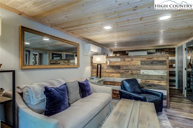 a bedroom with a bed couch and a window