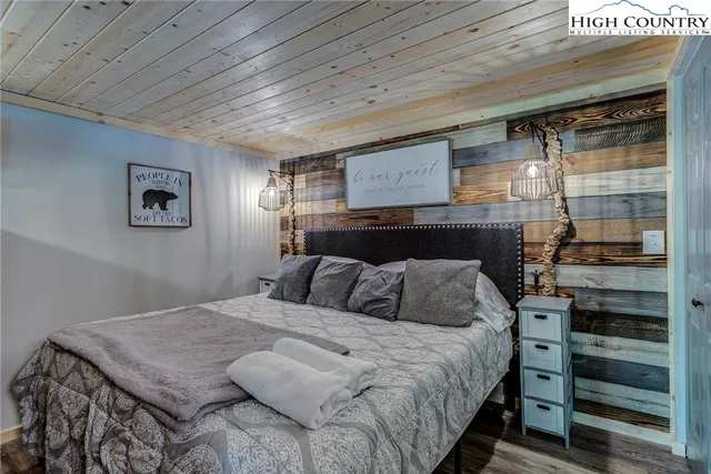 a bedroom with a bed and a television