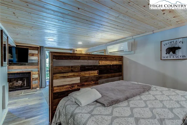 a bedroom with a bed and a large mirror