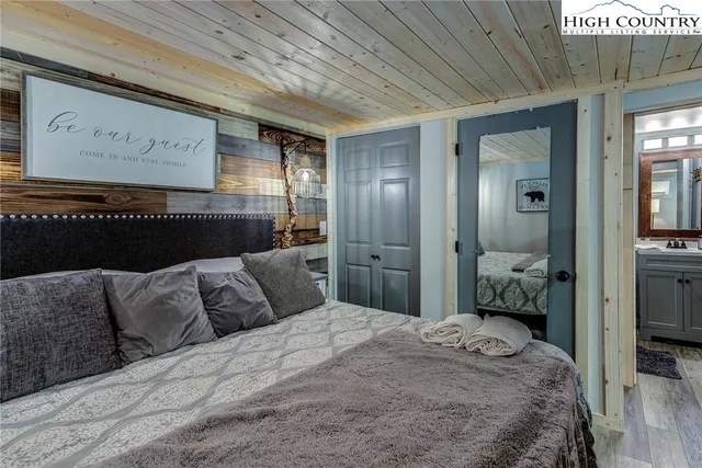 a bathroom with a granite countertop toilet sink and mirror