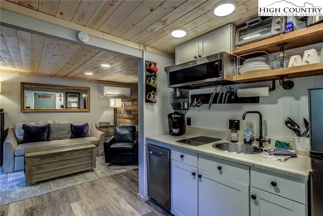 a kitchen with stainless steel appliances a sink and cabinets