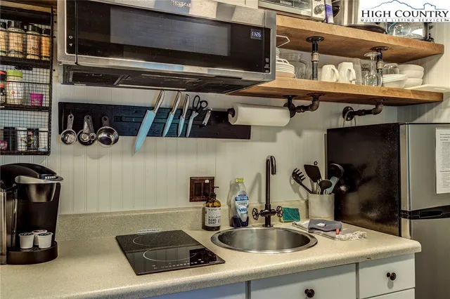 a kitchen with stainless steel appliances granite countertop a sink and cabinets