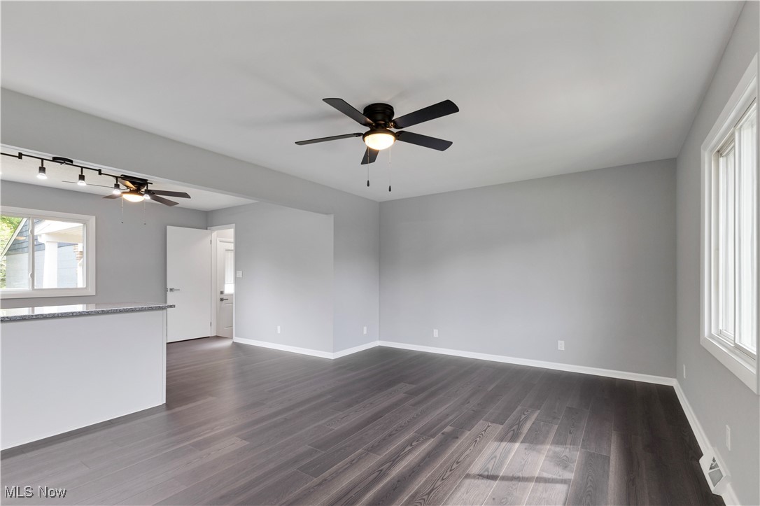3071 Call Road Stow, OH 44224 - Photo 4 of 25 Unfurnished living room featuring ceiling fan, dark hardwood / wood-style floors, and a wealth of natural light