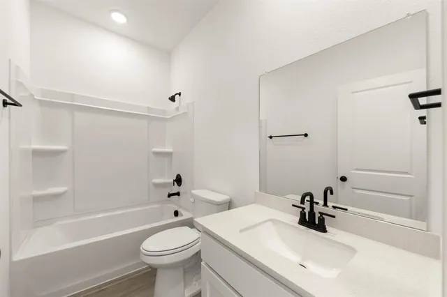 a bathroom with a sink a toilet and a tub