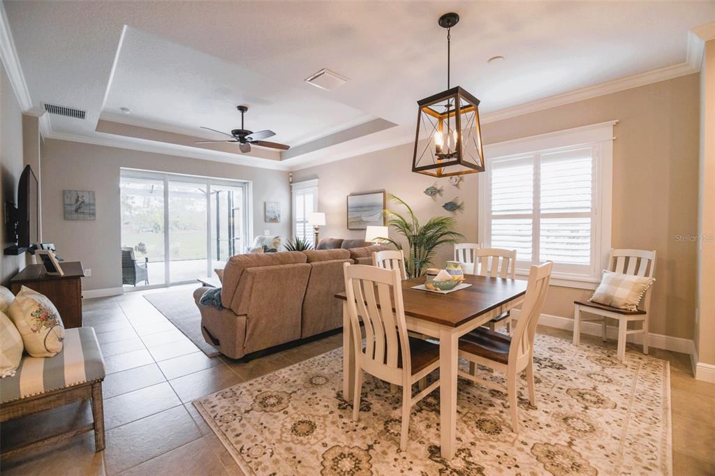 13153 Steinhatchee Loop Venice, FL 34293 - Photo 12 of 33 a living room with furniture a window and a chandelier