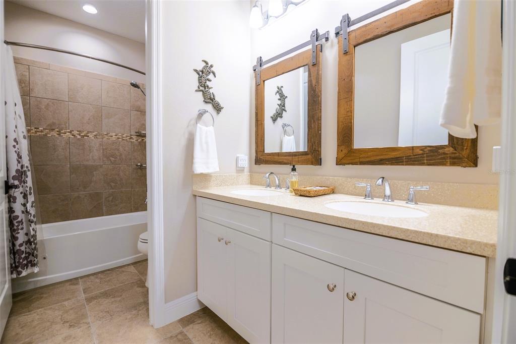 13153 Steinhatchee Loop Venice, FL 34293 - Photo 18 of 33 a bathroom with a granite countertop sink mirror and a