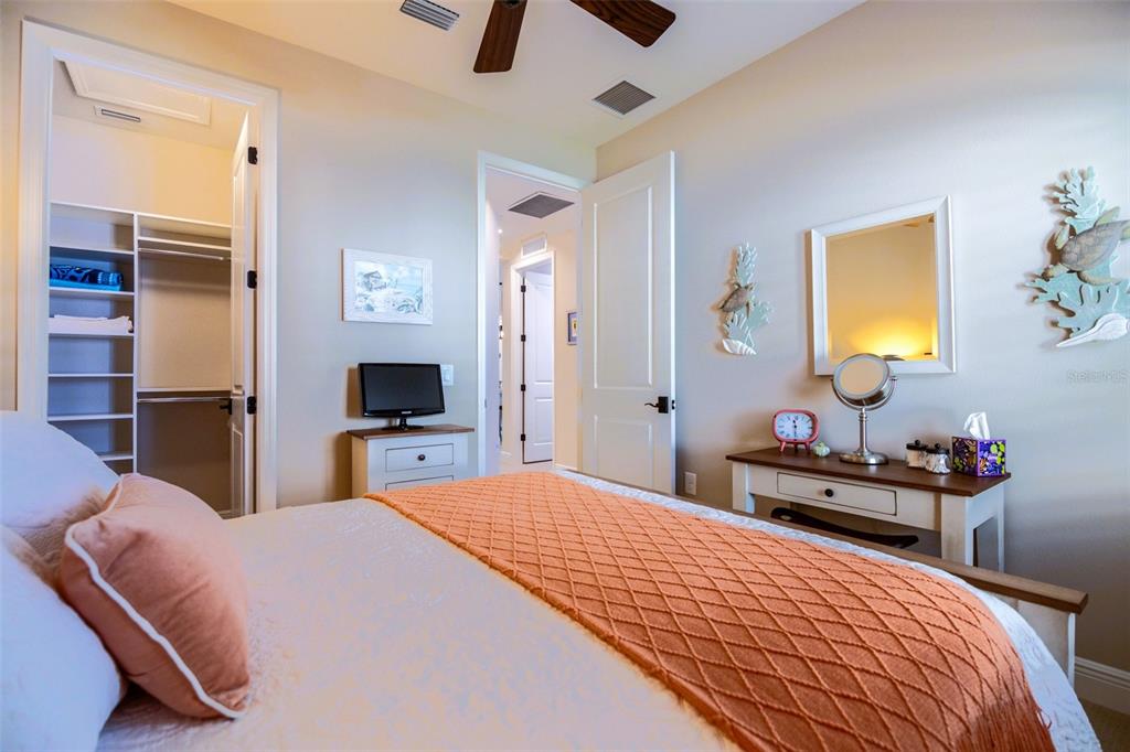 13153 Steinhatchee Loop Venice, FL 34293 - Photo 19 of 33 a bedroom with a bed and a chandelier