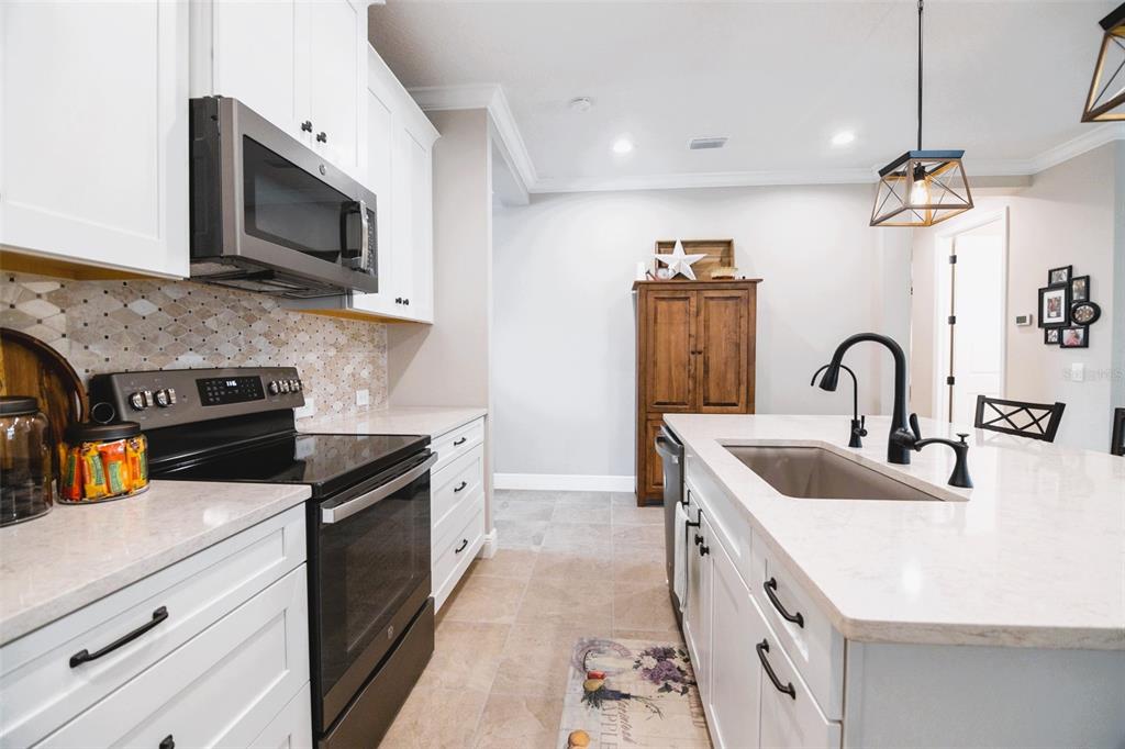 13153 Steinhatchee Loop Venice, FL 34293 - Photo 7 of 33 a kitchen with stainless steel appliances granite countertop a sink and a stove