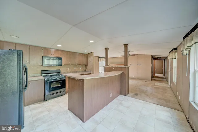 a kitchen with stainless steel appliances granite countertop a refrigerator oven a sink and dishwasher