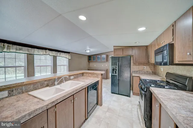 a kitchen with a sink stove and refrigerator