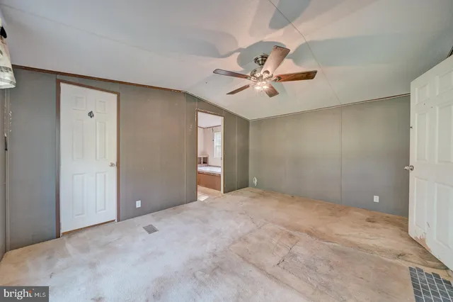 a view of a big room with closet and a ceiling fan