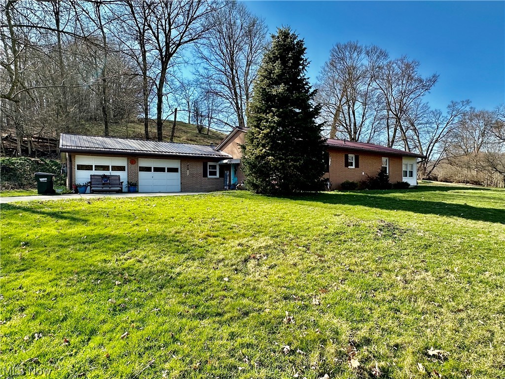 111 Fort Road Southwest Dellroy, OH 44620 - Photo 1 of 38 View of front of property featuring a garage and a front yard