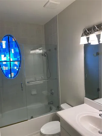 a bathroom with a sink toilet and shower