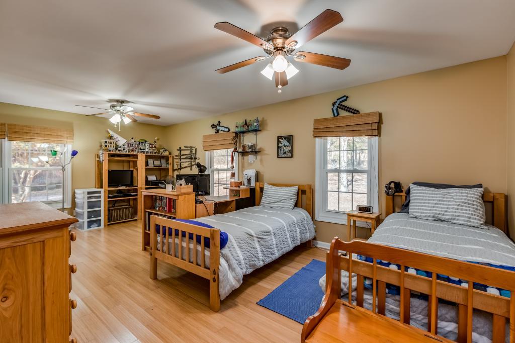 661 Beckwith Road Mount Juliet, TN 37122 - Photo 15 of 26 a bedroom with a large bed a chandelier and windows